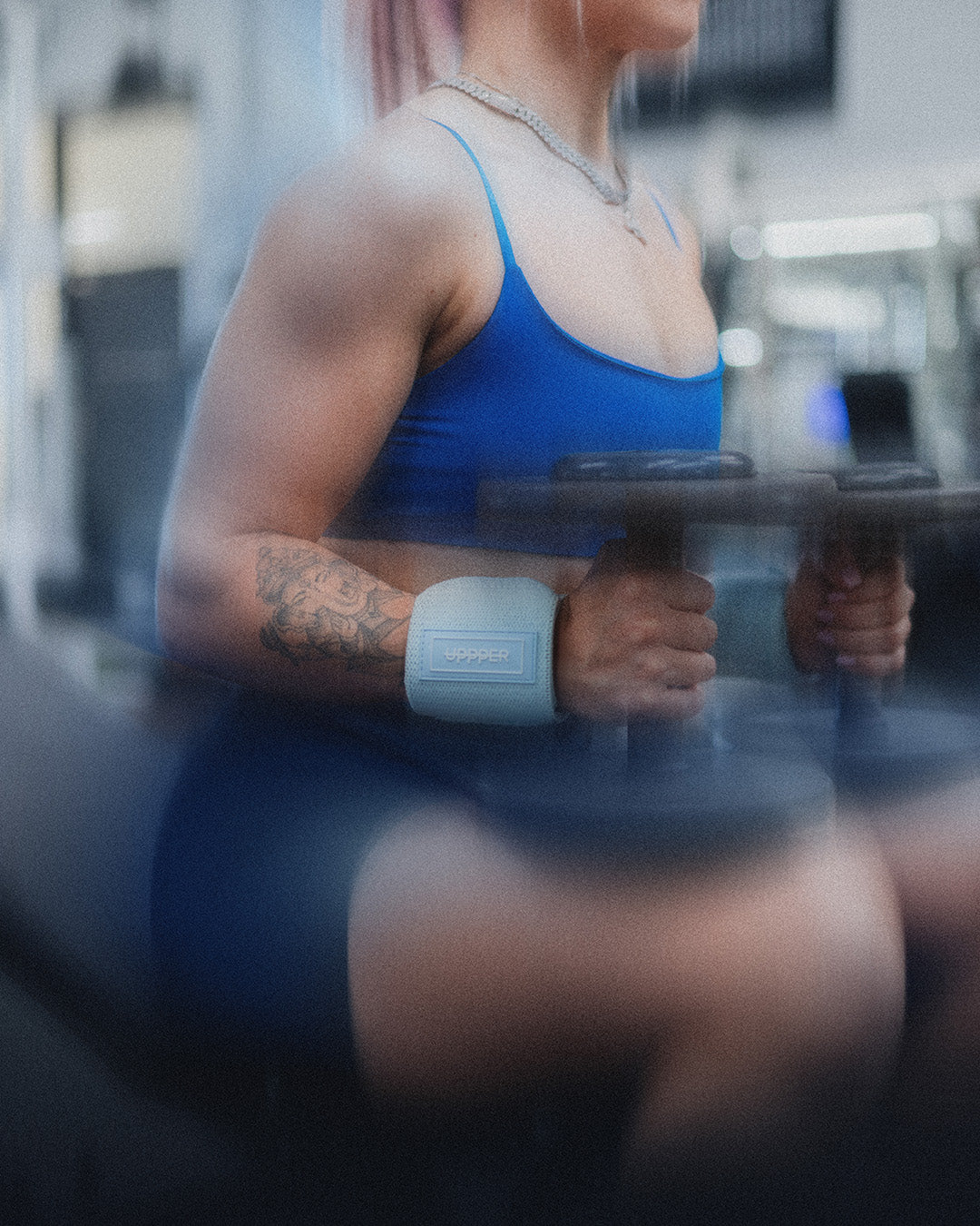 woman about to do upper chest exercise with uppper wrist wraps