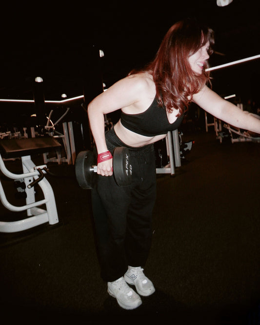 woman strength training with uppper lifting gear