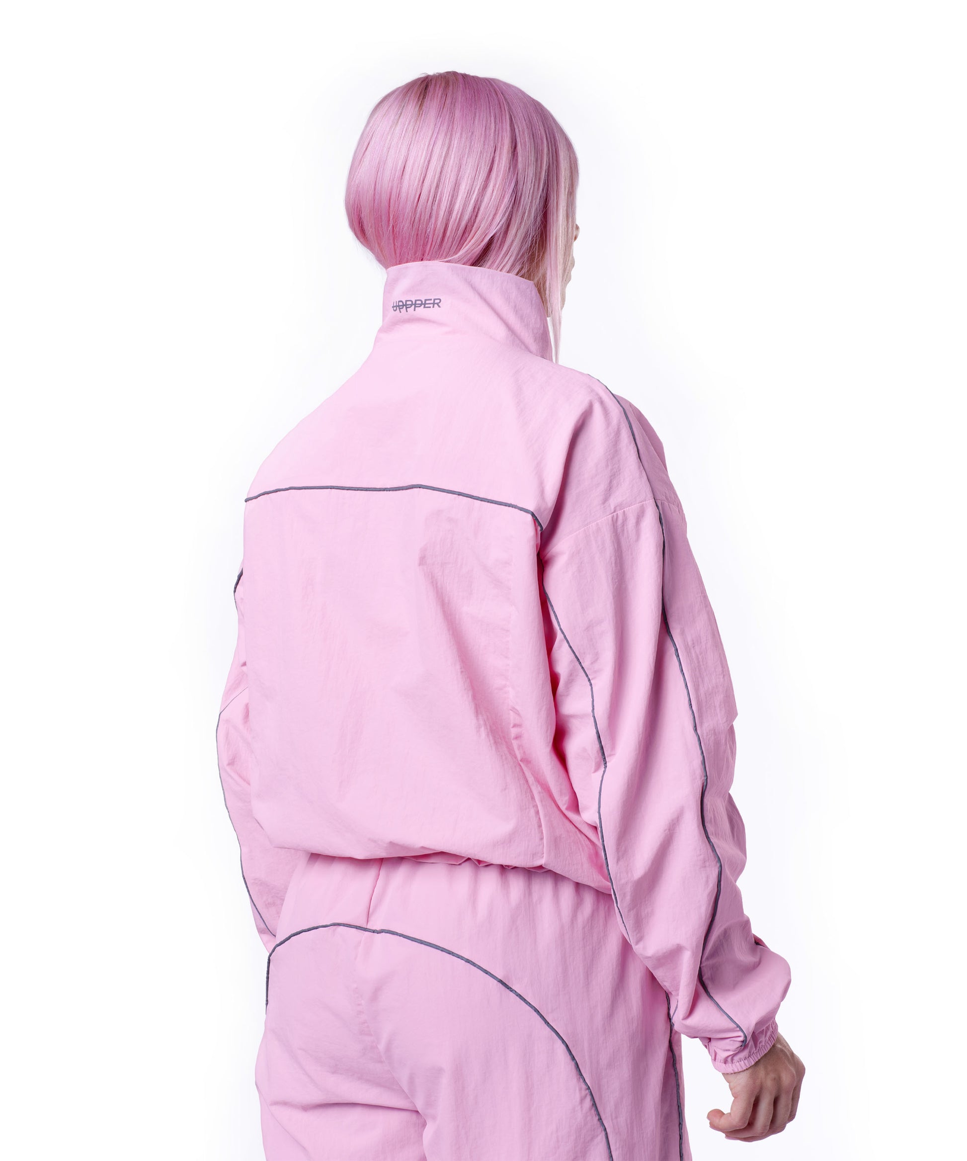back of pink uppper track jacket showing reflective lines on white background