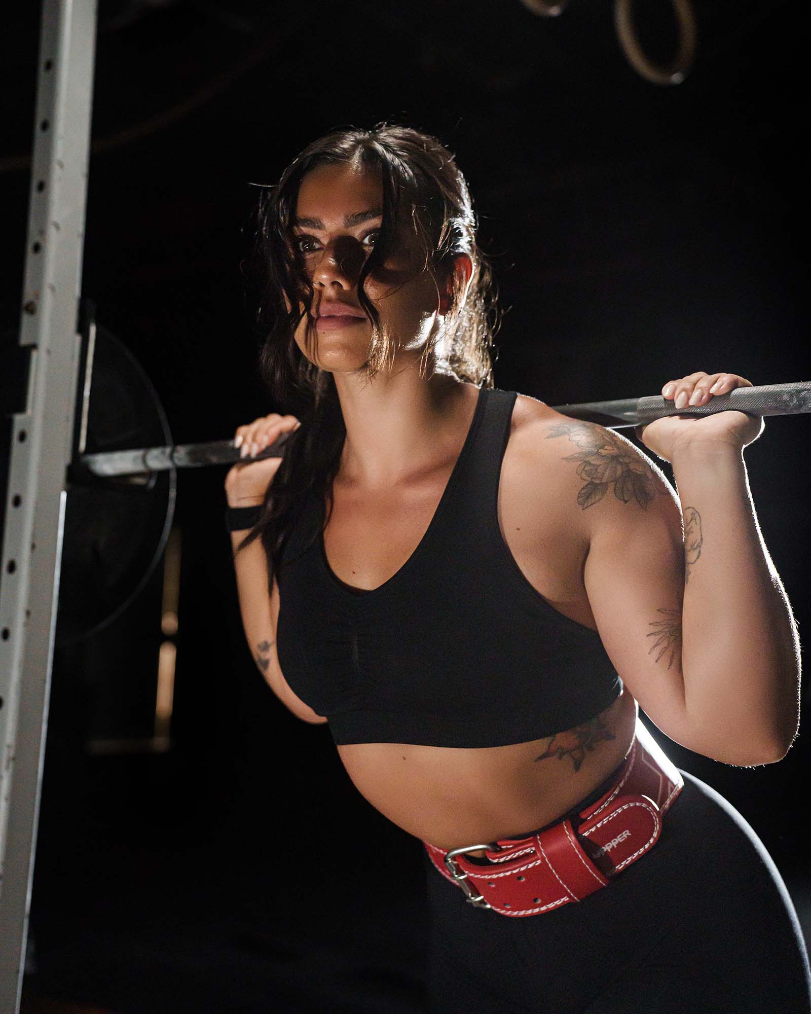 girl wearing red uppper lifting belt